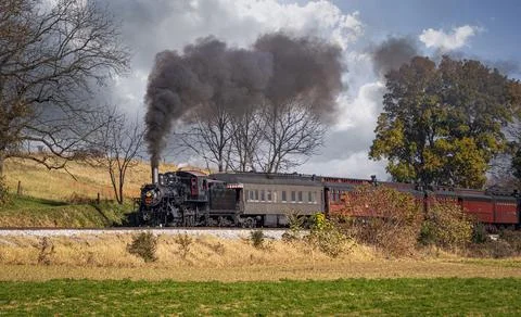 View of a Steam Passenger Train on a Single Track Going Thru Rural Countrysid Stock Photos
