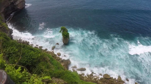 The view from a steep cliff above sea near Uluwatu Temple Stock Footage 295416620