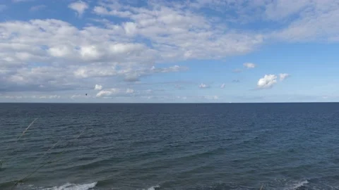 View from the steep coast to the ocean - some grasses in the foreground Stock Footage 139143047