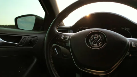 View of the steering wheel of a VW car. The sun's rays hit the steering wheel. Stock Footage 158661093