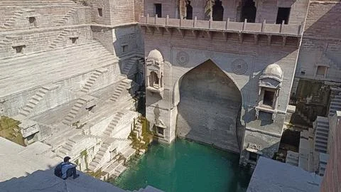 A view of Step well called Toorji ka Jhalra built with red stone Фото