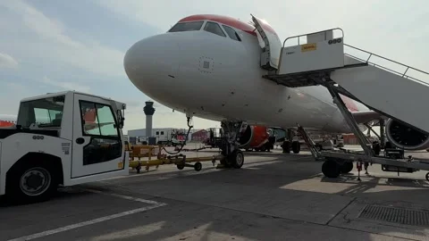 View to the steps and engines of parked airliner in airport Stock Footage 314341730