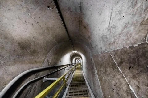 View of steps inside empty industrial concrete tunnel, diminishing perspectiv Stock Photos