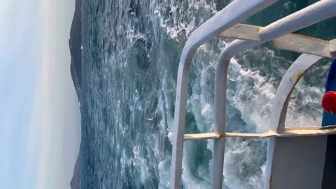 View from the stern of the ship to the island - Vertical stock video Stock Footage 239640798