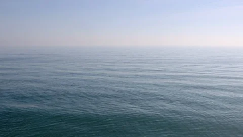 View of a stone beach with a clean transparent water and relaxing waves Stock Footage 125562142