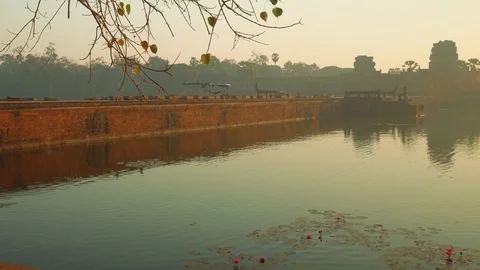 View of stone bridge leading to Angkor Wat temple early in morning. It's closed Stock Footage 88409190