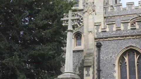 A view of a stone cross in front of an old church. Stock Footage 137213446