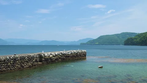 View of stone jetty at the beach in Izu Peninsula, Shizuoka, Japan Stock Footage 312377567