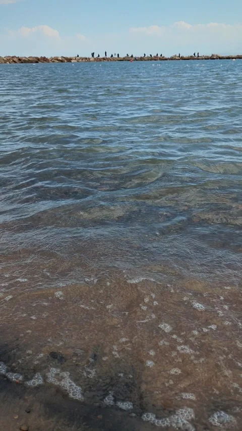 View of the stone spit from the shore of the lake Video stock 295488874