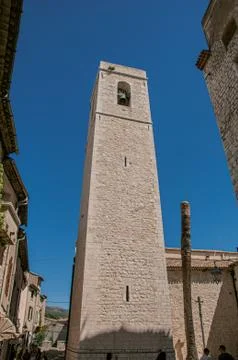 View of stone steeple tower next to church in Saint-Paul-de-Vence. Stock Photos