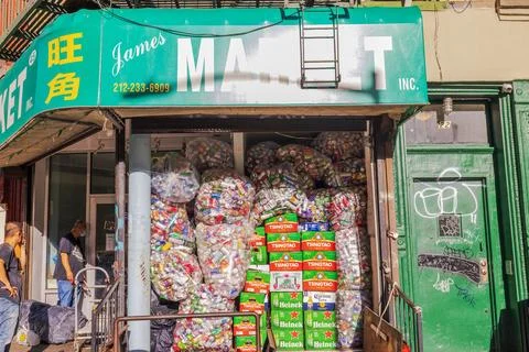 View of storefront storing bags of empty beverage cans and plastic bottles. Stock Photos