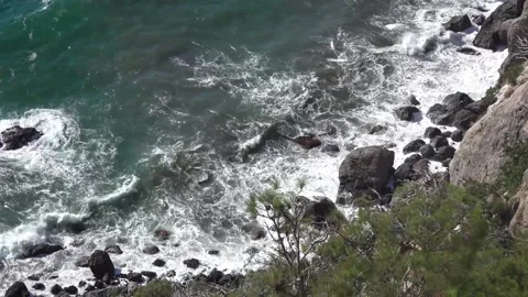 View on the stormy ocean from rocky mountain Stock Footage 130811357