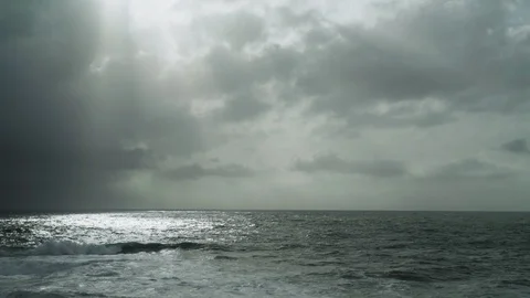 View of the stormy sea. Dramatic sky. Sunlight breaks through the clouds Stock Footage 124485164