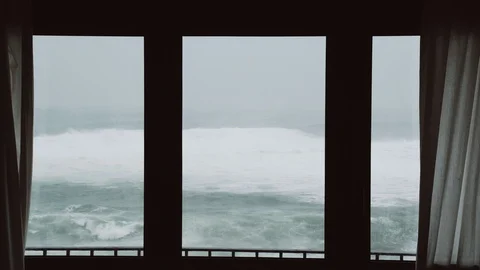 View of the stormy sea from the window. Watching the storm. Severe raging sea Stock Footage