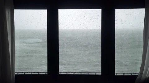 View of the stormy sea from the window. Watching the storm. Severe raging sea Stock-Footage 124485773
