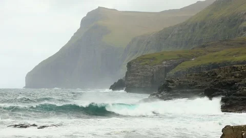 View of stormy surf from the village of Eiði in the Faroe Islands. Видео 154552239