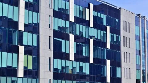 A view at a straight facade of a modern building Stock Photos