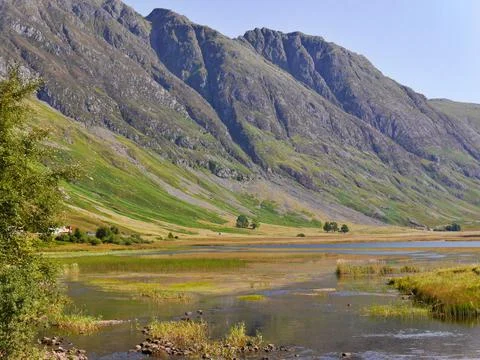 View of stream flowing through Glencoe valley, Scottish Highlands Stock Photos