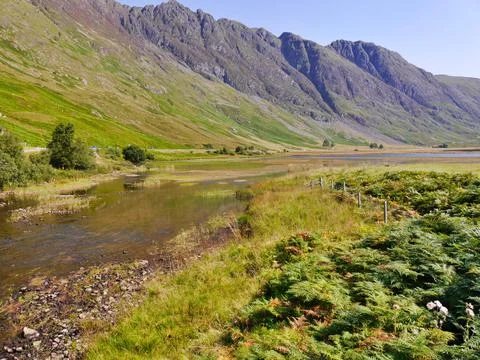 View of stream flowing through Glencoe valley, Scottish Highlands Stock Photos