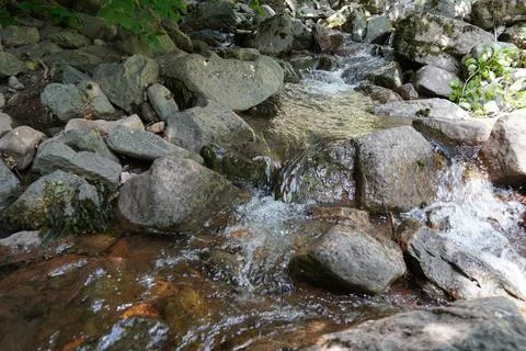 View of streambed and blue sky in cliffs Stock Photos