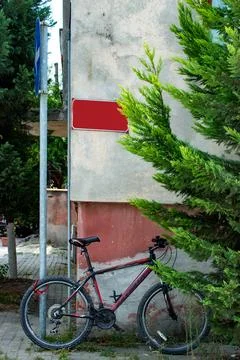 View of the street. Empty post space on the red sign on the wall. Stock Photos