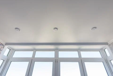View of the stretch edafter ceiling and part of the glazed-to-ceiling windows Stock Photos
