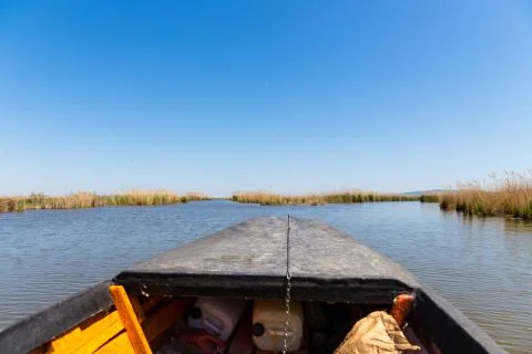 View of the stubble fields while crossing the river on a wooden boat Stock Photos