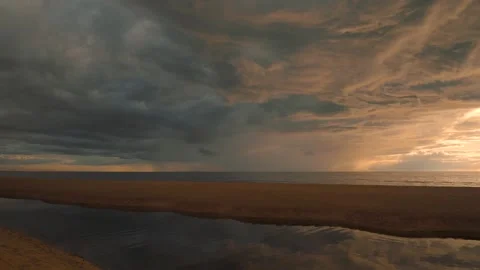 View of stunning sunset with rain clouds from sandy beach Stock Footage 295215335