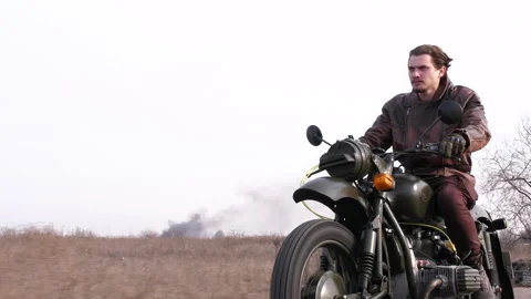 View of stylish cool man in leather jacket riding motorcycle Stock Footage 152865322
