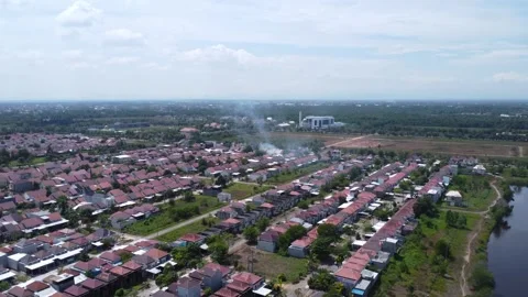View of subsidized and commercial housing in Banjarmasin, and visible smoke.. Stock Footage 283889355