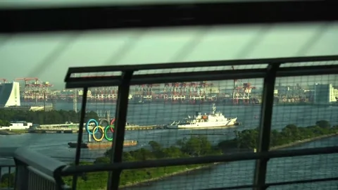 View from subway in movement of the Olympic rings in sea side Tokyo japan Stock Footage 155985979