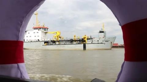 A view of a suction dredger  through a lifebuoy on a ferry Stock Footage 223358599