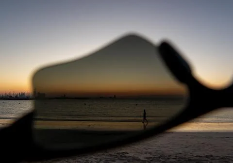 View to summer beach seaside through sunglasses shot in the evening Stock Photos