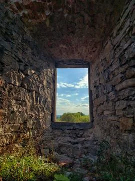 View of a summer landscape through a stone window arch in an ancient ruin Fotos de archivo