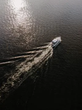 View on the summer sunset on the river with white boat Stock Photos