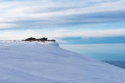 View from a summit of Sierra Nevada of some rocks in winter, with everything  Stock Photos