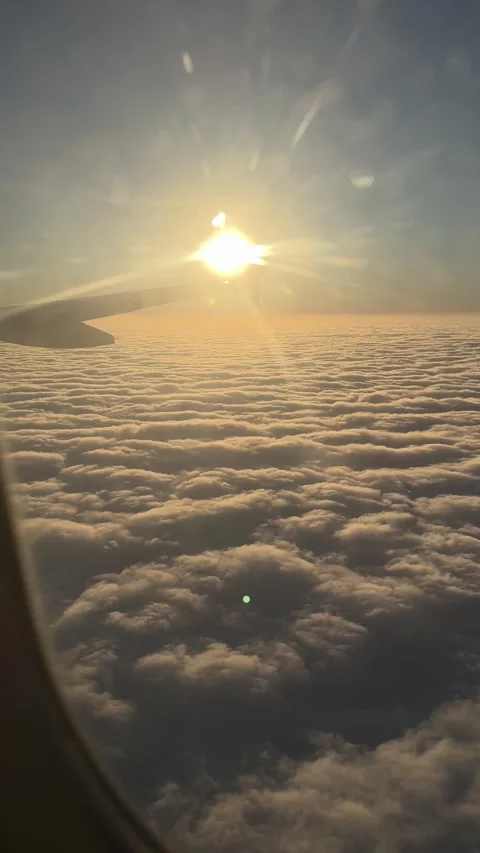 View of sun above thick clouds from airplane window. Vertical video Stock Footage 262365070