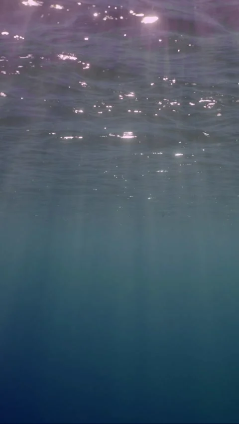 View of sun light from blue abyss, slow motion Stock Footage 252015649