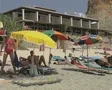 View of sun loungers and people on beach SD Footage