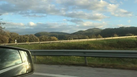 View on sun reflection in side mirror from vehicle on motorway Stock Footage 118339346