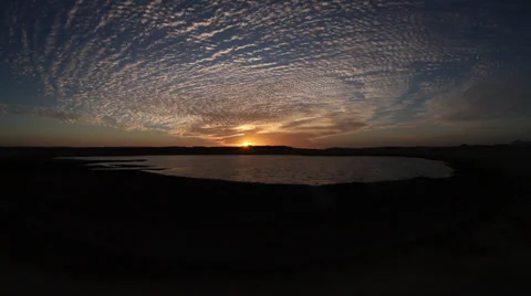 View of the sun setting behind a salt lake in Ras Mohamed, Sinai, Egypt Stock Footage 39195155