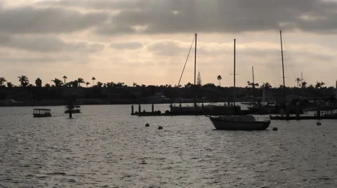 View of sun setting on a cloudy afternoon in harbor pans back and forth as th Video stock 67466009