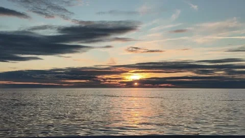 View of the sun setting from a moving boat Stock Footage 318492619