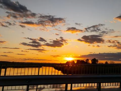 A view of the sun setting over a body of water Stock Photos