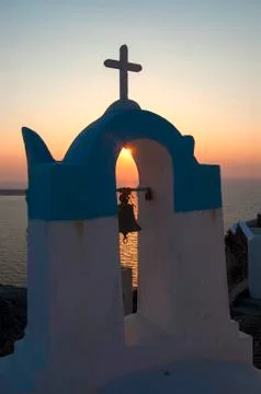 View of the sun at sunset through the bell tower of a typical church in santo Stock Photos