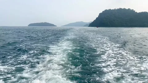 A view of the Sunda Strait showing a blue-green sea surface with waves and Stock Footage 345774301