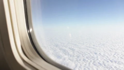 View of sunlit white clouds from the airplane or jet window Stock Footage 233480833