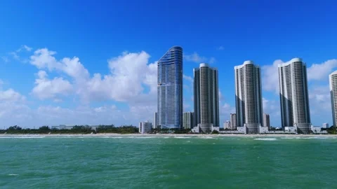 View of Sunny Isles Beach featuring several tall, modern skyscrapers along Stock Footage 295551996