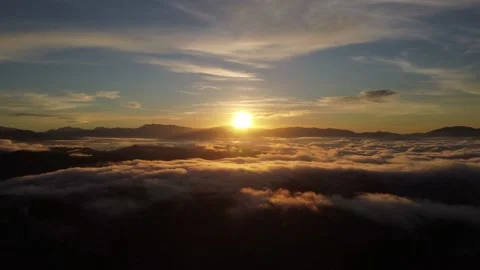 View of the sunrise over the clouds unde... | Stock Video | Pond5