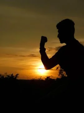 View of sunset and a man doing martial arts Stock Photos